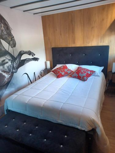 a bedroom with a bed with a horse on the wall at Leonchic - Guest House com Piscina de Água Salgada in Barcelos