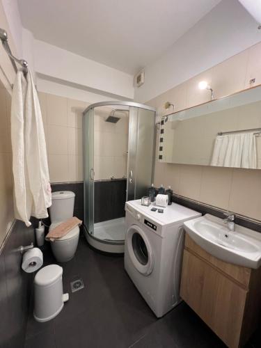 a bathroom with a washing machine and a sink at Horizon Hotel in Chora Folegandros