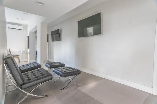 a living room with a black chair and a television at The Biscayne Hotel in Miami