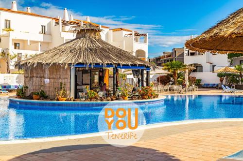 a sign in front of a swimming pool at a resort at Apartment Fairways Club in San Miguel de Abona