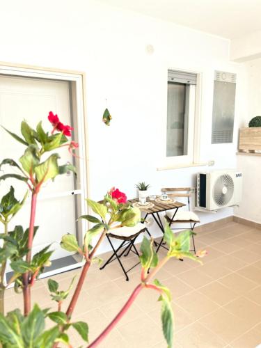 a balcony with a table and chairs and a plant at Settembre in Sannicandro di Bari