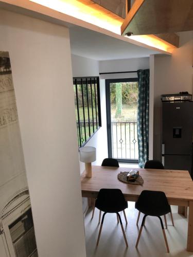 a dining room with a wooden table and chairs at Gîte de Coussane 2 in Espalion