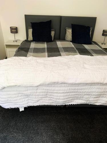a large white bed with two pillows on it at Erehwon - History in Bodmin in Bodmin