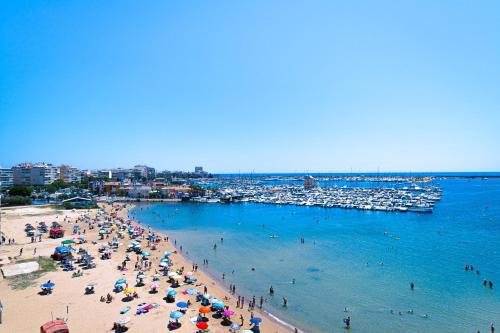 a group of people on a beach with boats at Santomera 1st Line in Torrevieja
