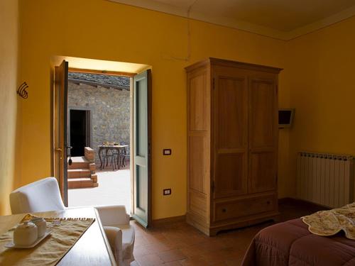 a bedroom with a bed and a door to a patio at Costa D'Orsola in Pontremoli