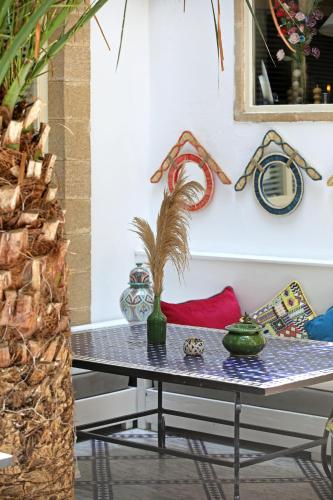 a table with a plant on it in a room at Riad Dar L'Oussia & SPA in Essaouira