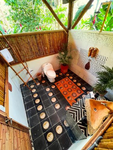 an overhead view of a bathroom with a toilet at Salvia Madre Hotel Boutique in Guachaca
