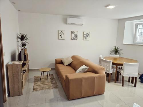 a living room with a couch and a table at Apartment GAJA, Koper in Koper