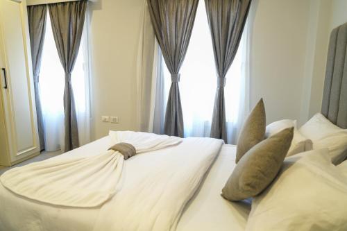 a bedroom with a bed with pillows and a window at Villa 55 in 6th Of October