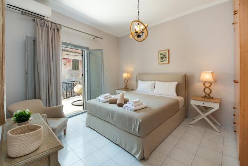 a bedroom with a bed and a living room at Marilu's, Paxos Port House in Gaios