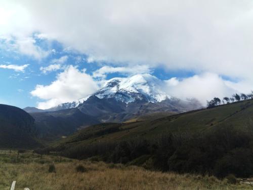 a snow covered mountain on top of a hill at Chimborazo Basecamp in Chimborazo