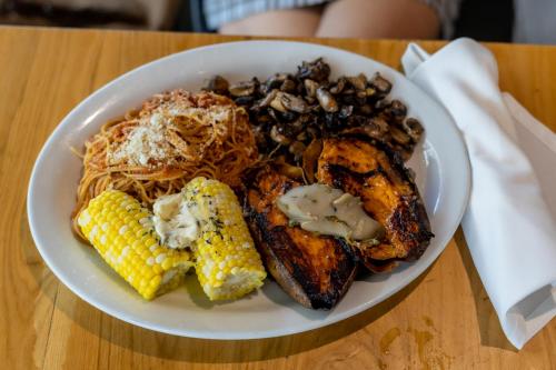 a white plate of food with corn on the table at The Biscayne Hotel in Miami