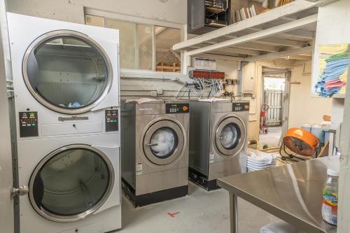 a laundry room with two washing machines and a table at The Biscayne Hotel in Miami