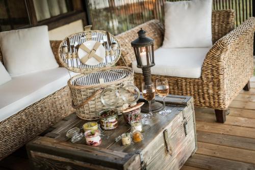 a table with wine glasses and a lamp on it at Villa Vanille in Boisseron