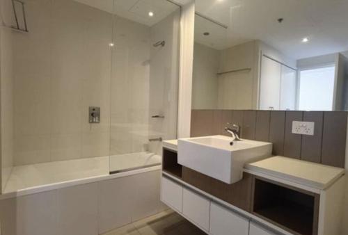 a bathroom with a sink and a bath tub and a sink at AAB Apartments Skyline in Brisbane