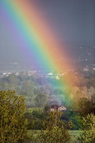 a rainbow in the middle of a field at Cascina La Maddalena Bed & Wine in Rocca Grimalda