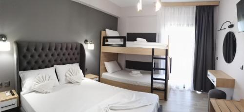 a bedroom with two beds and a bunk bed at Katerina's Resort in Sarti