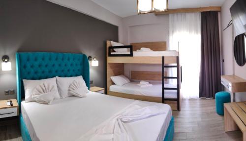 a bedroom with a bed and a bunk bed at Katerina's Resort in Sarti