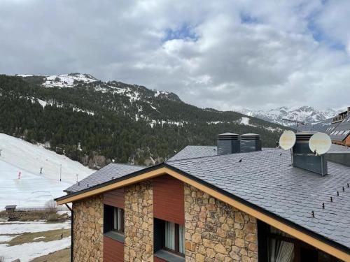 a house with satellites on the roof of a mountain at HOLA ANDORRA - family apartment in Bordes d´Envalira