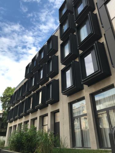 un bâtiment avec des fenêtres noires sur son côté dans l'établissement Design Gallery INBP07 Studio Apartment #freeparking, à Budapest