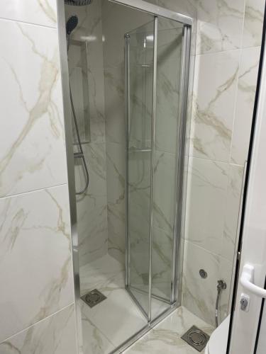 a shower with a glass door in a bathroom at Draga in Ulcinj