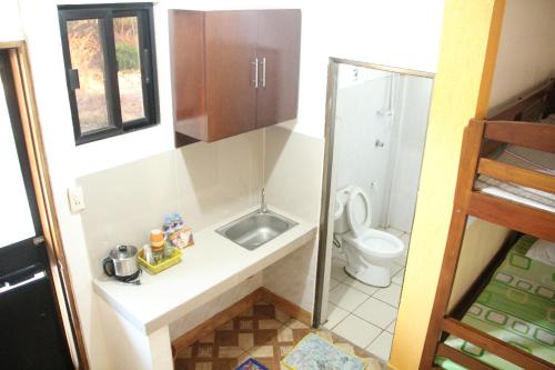 a small bathroom with a sink and a toilet at Good Guys Beach Resort in Botolan