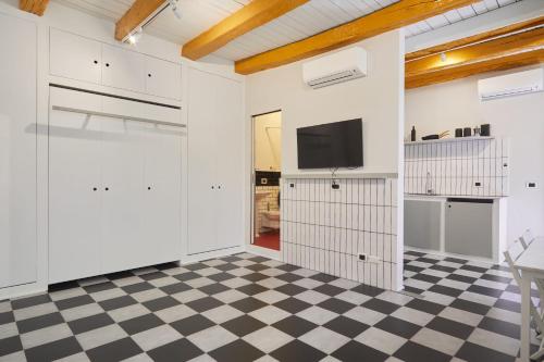 Zimmer mit weißen Wänden und kariertem Boden in der Unterkunft Incantevole appartamento in darsena in Mailand
