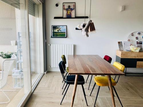 a dining room with a wooden table and chairs at UPLÈ family bike apartment in Lecce