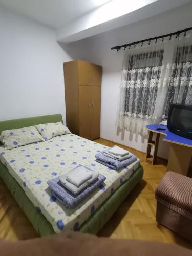 a bedroom with a bed with towels on it at IS Guest House in Ohrid