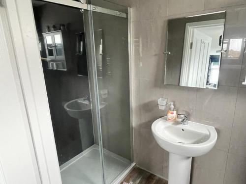 a bathroom with a shower and a sink and a toilet at Godrevy Lighthouse View, Carbis Bay, St Ives, free parking near beach in Carbis Bay