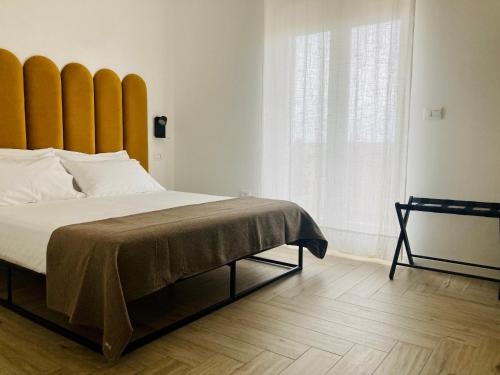 a bedroom with a large bed with a large window at UPLÈ family bike apartment in Lecce