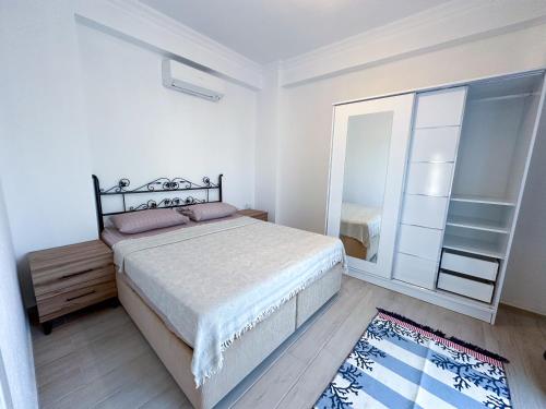 a bedroom with a large bed and a mirror at Villa Seray Datça in Datca