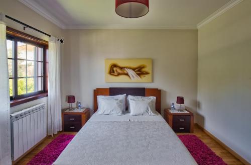a bedroom with a large bed with two night stands at Suite em Viana do Castelo in Viana do Castelo