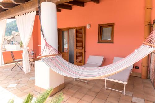 a hammock on the patio of a house at Residence Alberghiero Eolie in Lipari