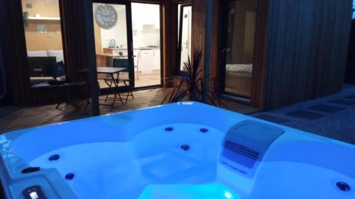a bath tub in a room with a living room at L'Eden in Frehel