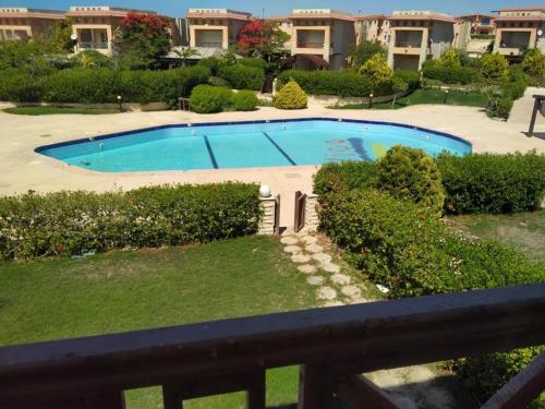 a view of a swimming pool from a balcony at 4 bedroom Villa with private terrace, pool, and garden in El Hamam