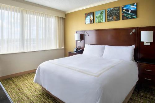 a hotel room with a large bed and a window at Boston Marriott Peabody in Peabody