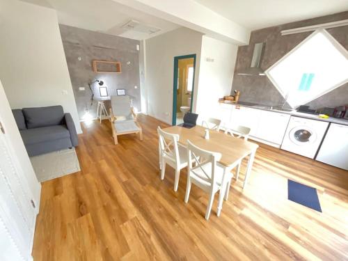 a living room with a table and chairs and a couch at Apartamento Mouzinho in Horta