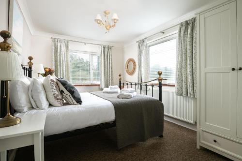 a bedroom with a bed and a window at End Cottage in Fakenham