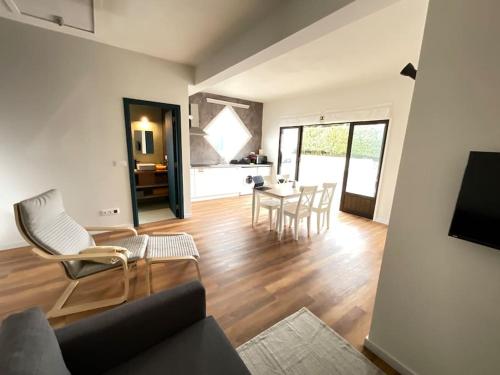 a living room with a couch and a table with chairs at Apartamento Mouzinho in Horta