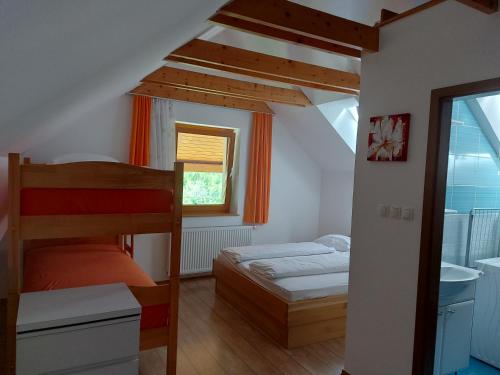 a bedroom with two bunk beds and a bathroom at Apartments and Rooms Martuljk in Kranjska Gora