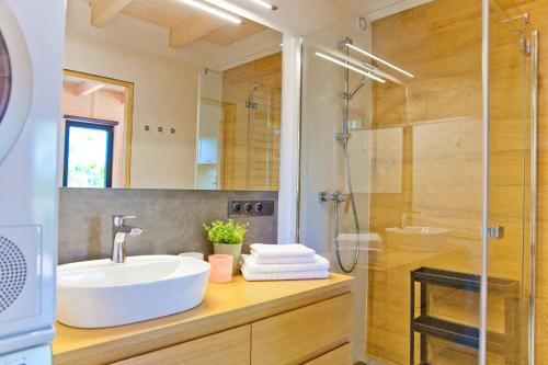 a bathroom with a sink and a shower at Lilla House in Sasino