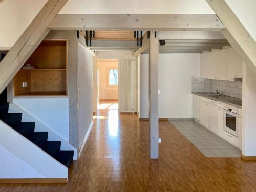 a kitchen with white cabinets and a staircase at The St.Gallen Feel in St. Gallen