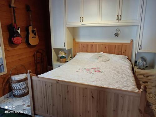 a large bed in a bedroom with guitars on the wall at Home Il Cortiglione in Frascati