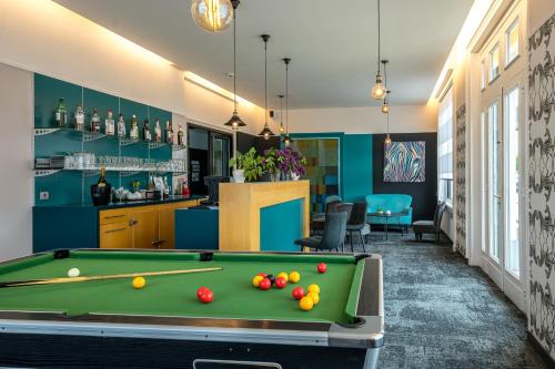 a pool table in a room with a bar at Best Western Adagio Saumur in Saumur