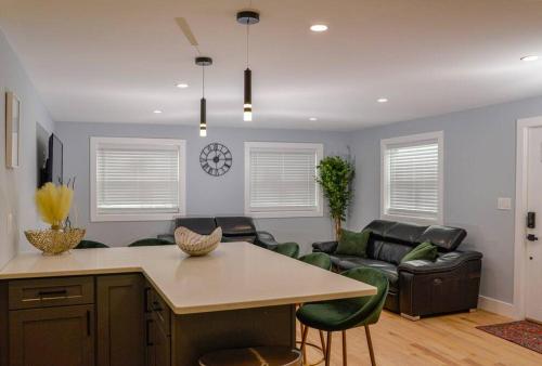 a kitchen and living room with a table and a couch at LakeAccess 4 Bed 3 Full Bath HOT TUB in Billerica
