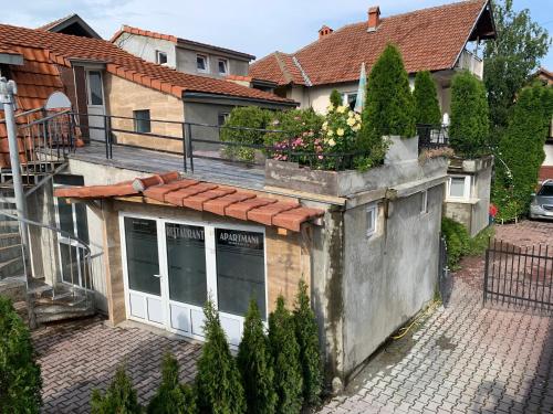 an old building with a window and a roof at APARTMANI & RESTORAN -S O K O- SJENICA in Sjenica