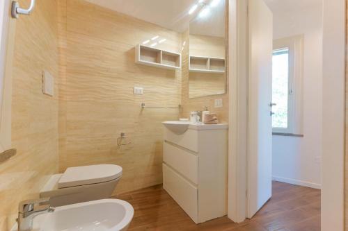 a bathroom with a toilet and a sink at B&B Villa Zola in Capoterra