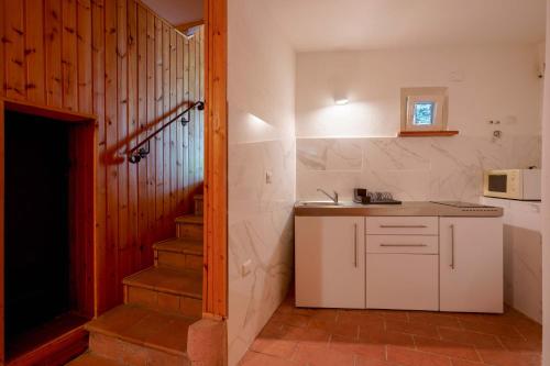 a kitchen with a sink and a staircase in a room at B&B Villa Zola in Capoterra