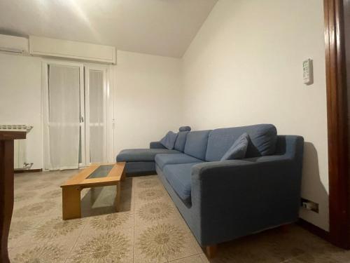 a living room with a blue couch and a coffee table at Ranco Lake Sunshine Apartment in Ranco